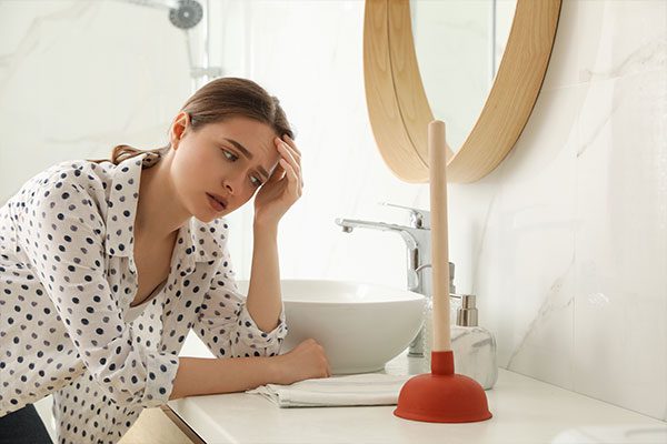 women over clogged drain